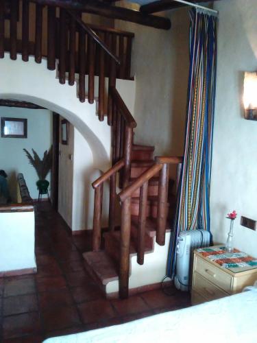 a room with a spiral staircase in a bedroom at El Rinconcito in Zahara de la Sierra