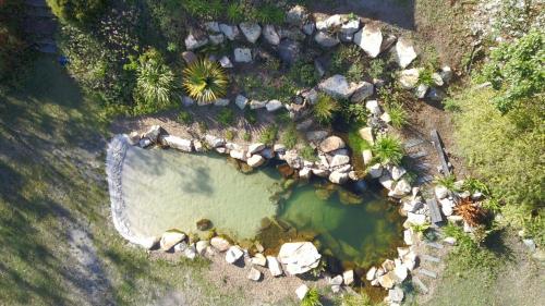 an aerial view of a pool of water with rocks at Casa Naranja - Off-grid Hideaway Agnes Water 1770 in Colosseum