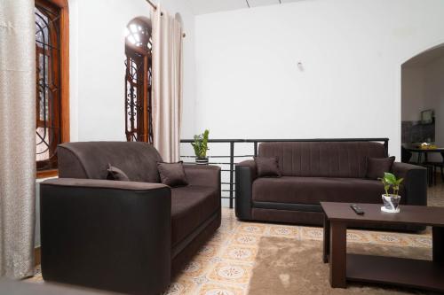 a living room with two couches and a coffee table at StayEase in Batticaloa