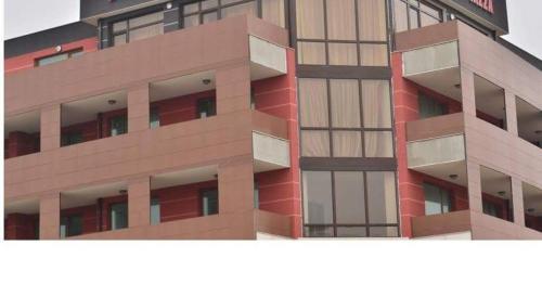 a tall building with a red at Apartment Kraev in Primorsko