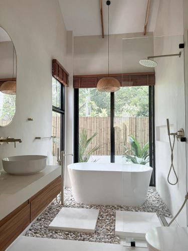 a bathroom with a large tub and two sinks at K Villas Phangan 03 in Ko Phangan