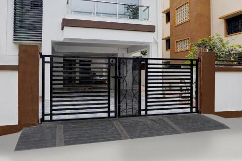 an open gate on a building with a balcony at HOTEL O AK Stay Inn in Dhantoli