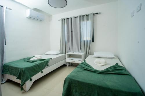 a bedroom with two beds and a window at Luxurious penthouse in Caleta, 2 minutes from the beach in La Romana