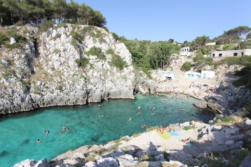 a group of people swimming in a body of water at Residence Borgo Antico in Diso