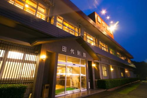 a building with lit up windows at night at Tashiro Annex in Yakushima