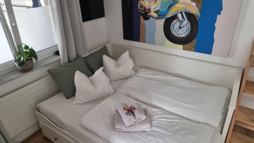 a bed with white pillows at Wohnung I im Vierländereck I Auszeit I Rheintal in Rebstein