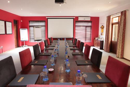 a conference room with a long table with chairs and water bottles at Casterbridge Hollow Boutique Hotel in White River