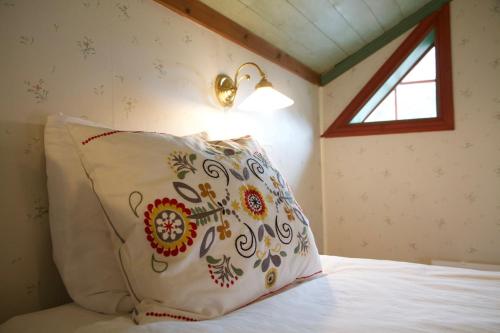 a bedroom with a bed with a pillow and a light at THE LODGE Torsby in Torsby