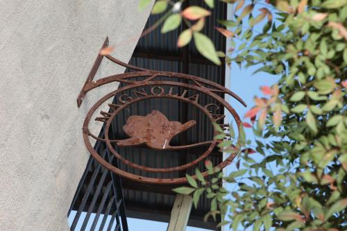 a rusty metal bird feeder attached to a building at Casterbridge Hollow Boutique Hotel in White River