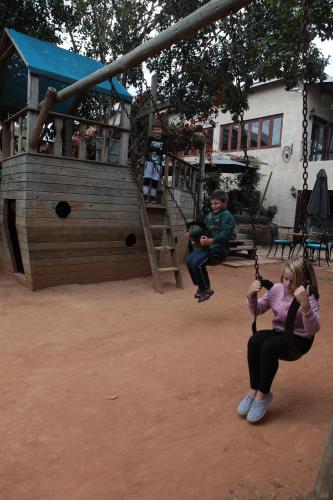 a young girl playing on a swing set at a playground at Casterbridge Hollow Boutique Hotel in White River