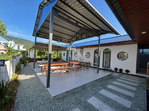 a patio with a table and chairs under awning at BÌNH MINH homestay - Vĩnh hy in Vĩnh Hy