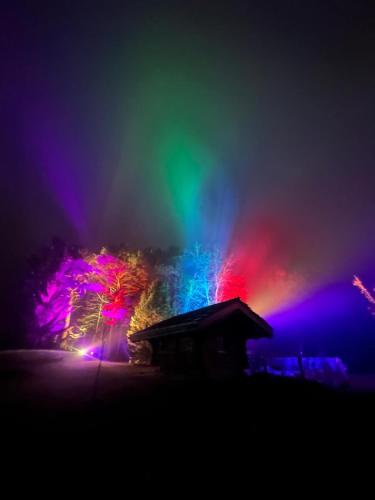 a rainbow in the sky over a building at night at WoodMood in Leuk