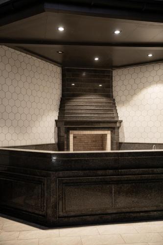 a stage in a room with a tiled wall at Turon Lux Hotel in Samarkand