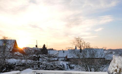 a winter sunset over a town with snow covered roofs at Gasthof Liederhalle in Aalen