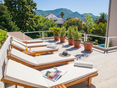 a patio with chairs and tables on a balcony at Hotel Casa del Mare - Blanche in Herceg-Novi