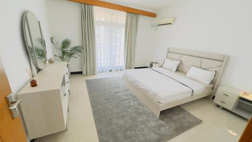 מיטה או מיטות בחדר ב-Lilas appartement
