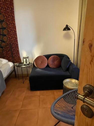 a living room with a couch with two pillows on it at Terracotta in Tʼelavi