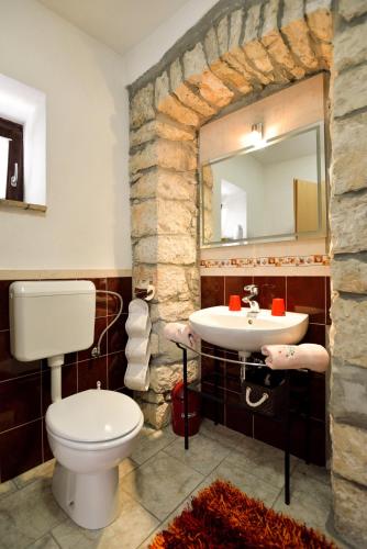 a bathroom with a white toilet and a sink at Apartment Julia in Nedeščina