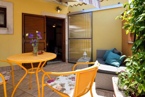 a patio with a table and chairs and a couch at Apartment Julia in Nedeščina