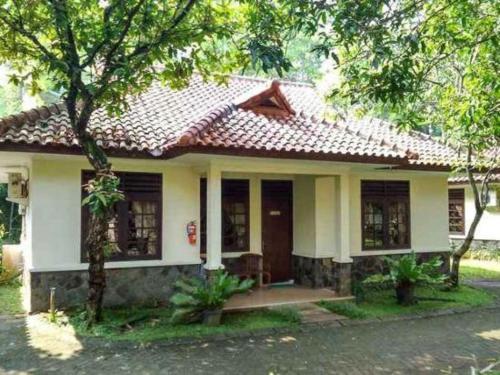 a small white house with a red roof at CICO Resort in Bogor