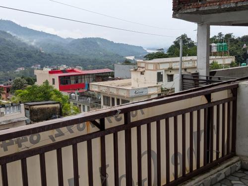 a view of a city from a balcony at MOONSHIVA STAY and CAFE in Rishīkesh