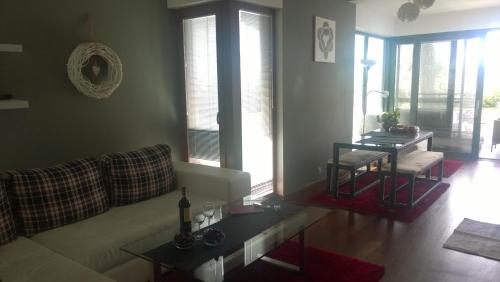 a living room with a couch and a table at Jurata Apartment in Jurata