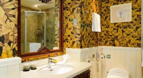 a bathroom with a sink and a mirror at Hangzhou The First World Hotel in Hangzhou