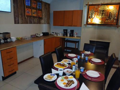 a kitchen with a table with plates of food on it at The Comfort Zone - Mthatha in Mthatha
