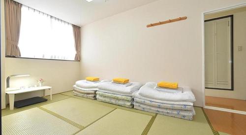 Postel nebo postele na pokoji v ubytování Business Hotel BL Kuwana
