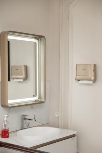a bathroom with a sink and a mirror at Turon Lux Hotel in Samarkand