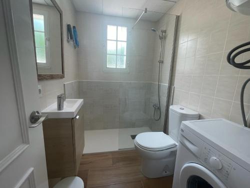 a bathroom with a shower and a toilet and a sink at Gregal - Castell Sol - Arenal de Castell in Arenal d'en Castell