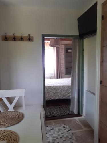 a mirror in a room with a bed and a bedroom at Au P'tit Versailles in Châtillon-sur-Seine