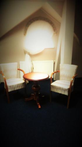 a room with two chairs and a table and a table and two chairs at Hotel Kamienica in Opole