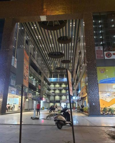 a motorcycle parked in the middle of a building at Hotel Rose inn in Surat