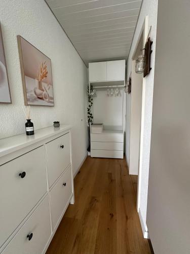 a room with a white dresser and a refrigerator at Gästehaus MaryVitty, zentrale zwischen Aarau und Olten, gut verbunden in Schönenwerd