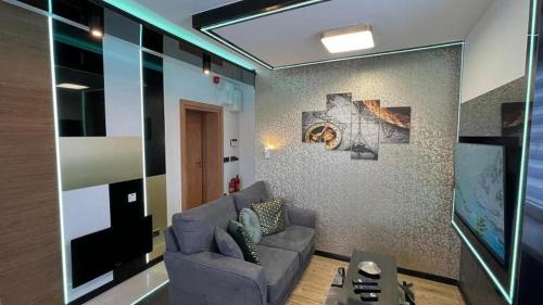 a living room with a couch and a tv at TGHA Luxury Apartments in Athlone in Athlone