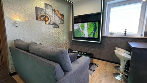 a living room with a couch and a television at TGHA Luxury Apartments in Athlone in Athlone
