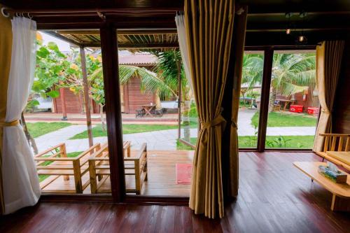 a room with a door open to a patio at TRÚ HOUSE in Mỹ Quang