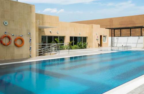 a large swimming pool in front of a building at Al Andalus Mall Hotel Jeddah in Jeddah
