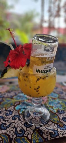 a glass of orange juice sitting on a table at TIANDE Boutique Hotel in Pwani Mchangani
