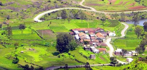 an aerial view of a house on a green field at Rajmudra Villa in Otūr
