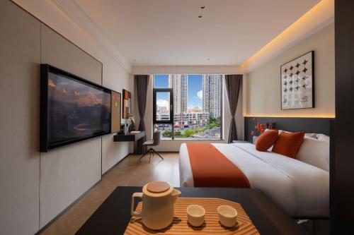 a hotel room with a large bed and a large window at LimitedEdition in Mienningting