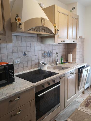 a kitchen with a sink and a stove top oven at La Terrazzetta Val Comelico in Santo Stefano di Cadore