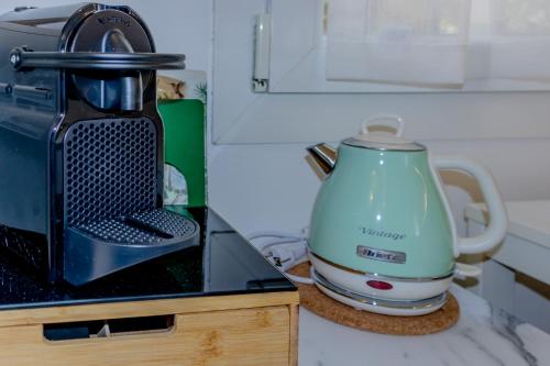 a tea kettle sitting on a counter next to a toaster at Bolhome Botanique-NR the Center in Bologna