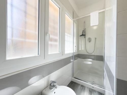 a white bathroom with a shower and a sink at Bolhome Botanique-NR the Center in Bologna
