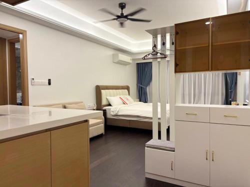 a kitchen and living room with a bed in the background at TheBess Hotel Tokyo is located adjacent to Singapore and offers a sea viewIt is a family business smart room with the sea view of Princess Bay富力公主湾 in Johor Bahru