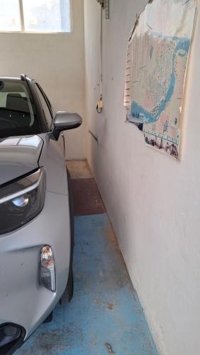 a car parked in a garage with a map on the wall at Ciranova 21 novi sad in Novi Sad