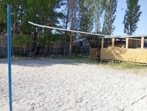 a volleyball court with a net in the sand at Tsovazard Glamping Park Sevan in Tsovazard