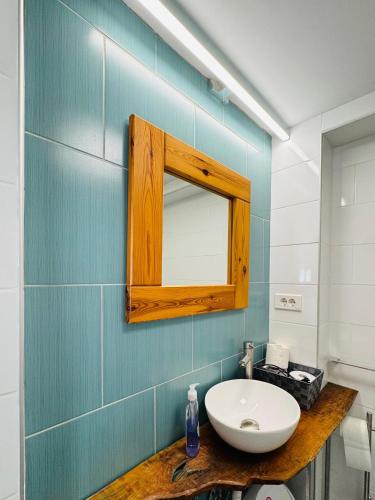 a bathroom with a sink and a mirror on the wall at Vila Eruga - Ap nr 4 in Poiana Mărului