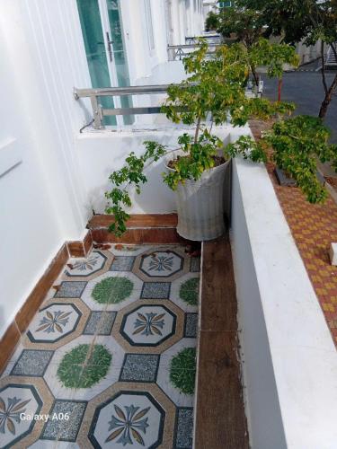 a balcony with a tiled floor with potted plants at MOTEL Đồng Khởi in Giồng Tú Ðiền
